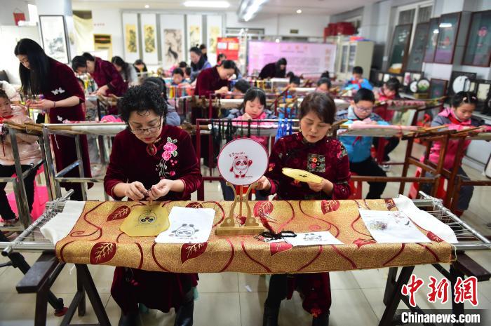 江西省級非遺豫章繡傳承人手把手指導(dǎo)小學(xué)生繡制2022年北京冬奧會吉祥物“冰墩墩”形象?！∮髟屏?攝