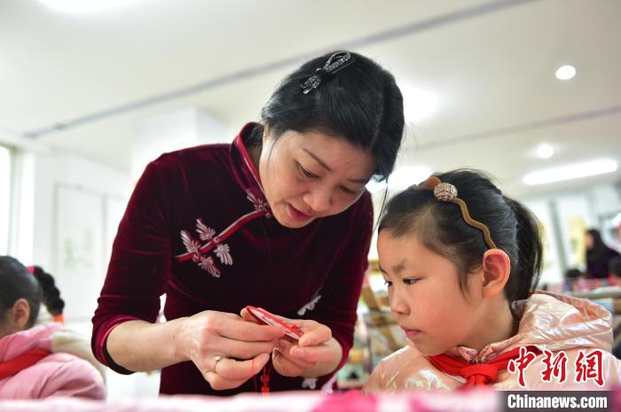 江西省級非遺豫章繡傳承人手把手指導(dǎo)小學(xué)生繡制2022年北京冬奧會吉祥物“冰墩墩”形象?！∮髟屏?攝