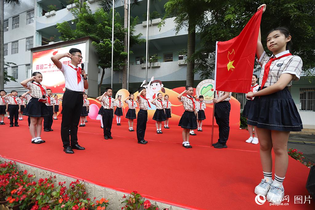 5月31日，在廣西壯族自治區(qū)南寧市民主路小學(xué)，學(xué)校大隊輔導(dǎo)員帶領(lǐng)少先隊員呼號。人民網(wǎng)記者 嚴(yán)立政攝