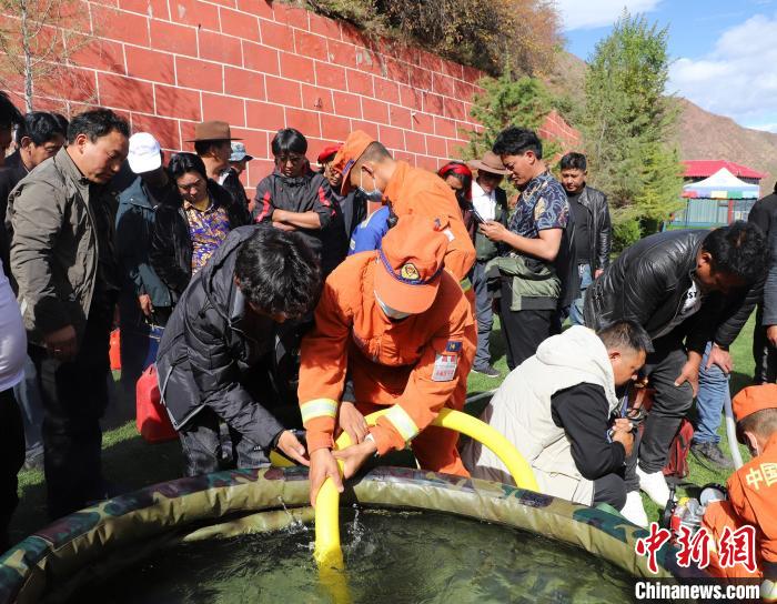 圖為森林消防員為護(hù)林員講解滅火裝備的使用方法。　昌都市森林消防支隊(duì) 供圖